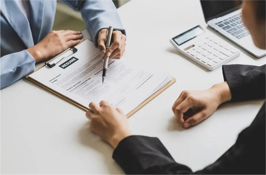 Deux personnes discutent du CV d'un candidat.